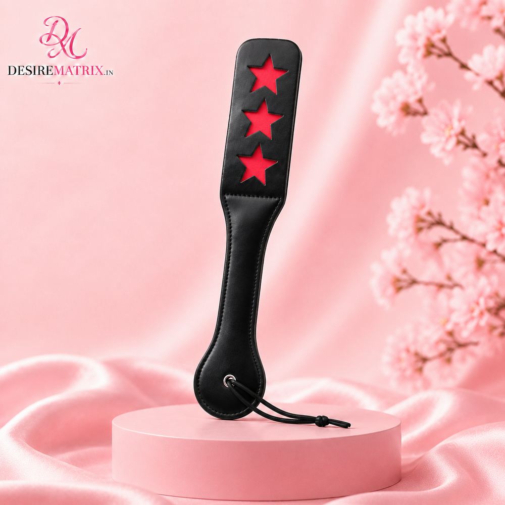 Black faux leather spanking paddle with three star cut-outs
