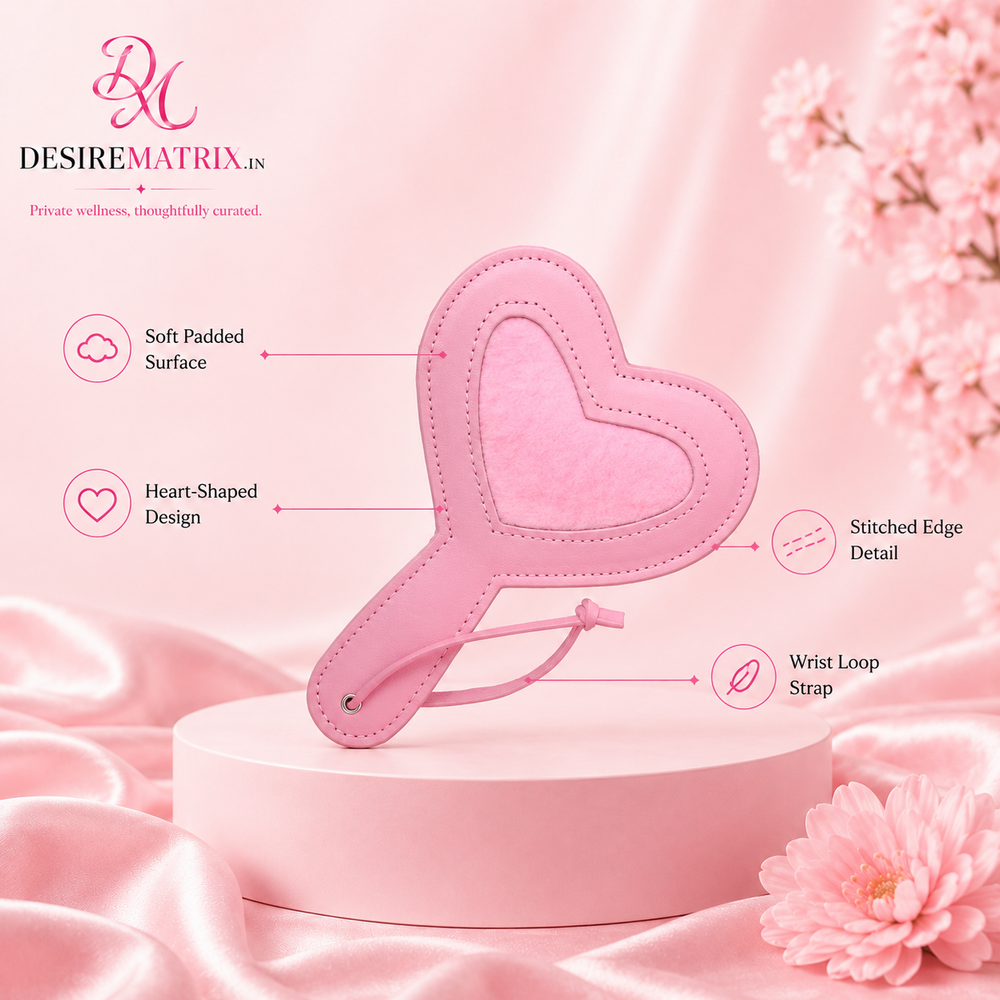 Heart shaped pink paddle shown flat with faux leather face